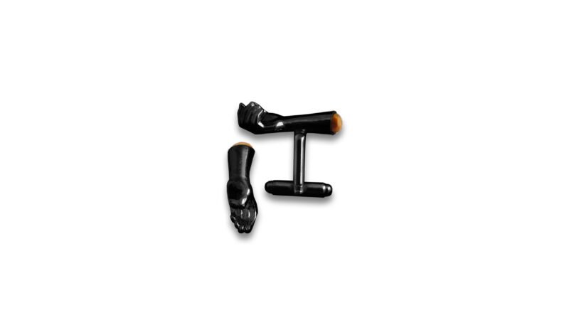Black varnish finish of Milius Act II Piece 03 “Retention Point I” with amber insert, conceptual cufflinks emphasizing vertical suspension, accumulated tension, and material containment.