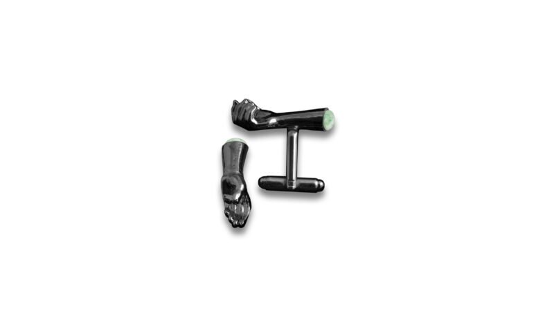 Ruthenium plated finish of Milius Act II Piece 03 “Retention Point I” with green stone insert, conceptual cufflinks emphasizing compressed tension, internalized force, and controlled containment.