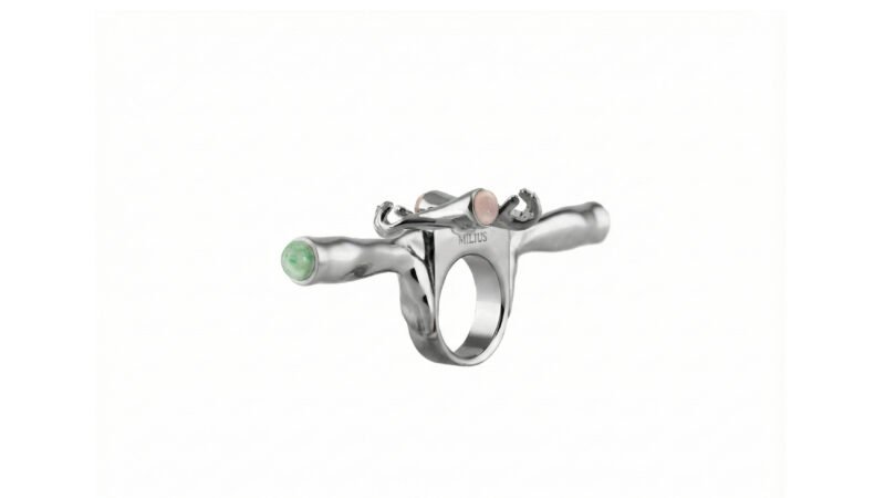 MILIUS Concentration ring in palladium finish with green semi-precious stone, sculptural jewellery detail.