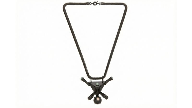 Front view of black varnished AXIS pendant by Milius for Luisa Via Roma, showing sculptural structure and gemstone settings.