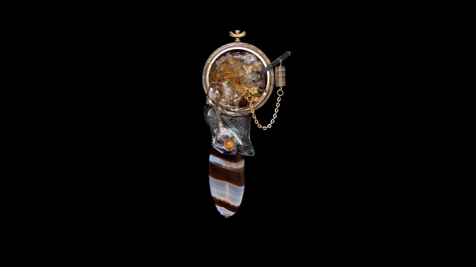 Mechanical relic pin from the Time Collection on black background