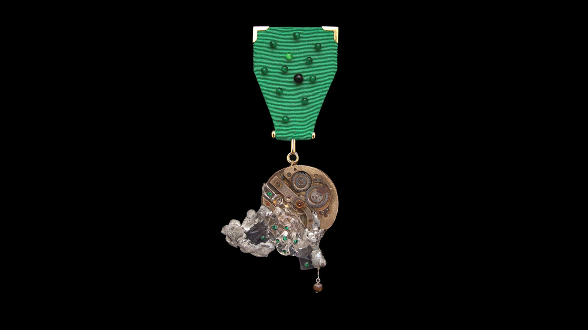 Mechanical gesture pin combining metal and textile from Time Collection Series II jewelry piece 4 isolated on black background, suspended organic wearable time object