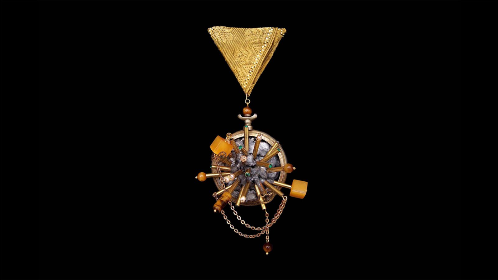 Applied arts pin featuring fragmented clockwork elements on dark background. Time Collection Series V jewelry piece 3 on black background, experimental time-based wearable sculpture