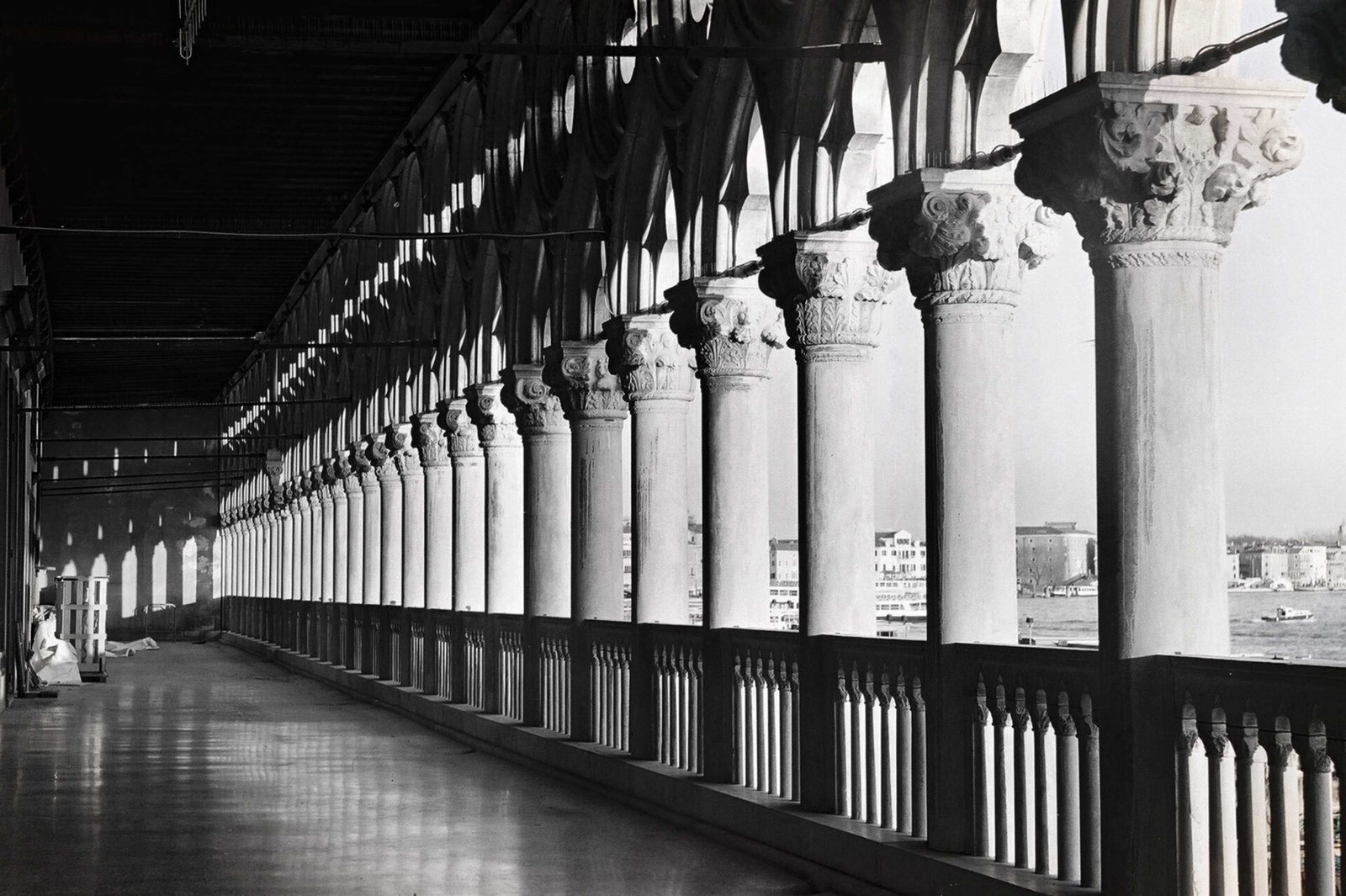 Colonnade with repeating stone pillars and shadow patterns photographed on analog film by Milan Stamenovic, exploring memory, architectural thought, and post-human space in Landscapes of the Remembering World.