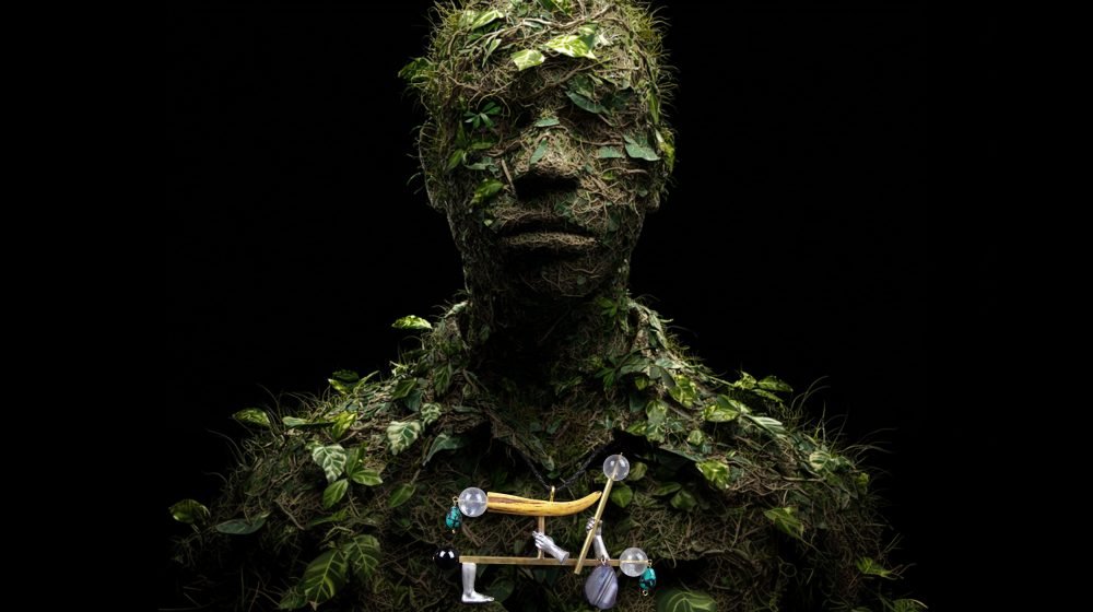 Wearable art jewelry from the Hunter Collection shown on a humanoid botanical totem, expressing alignment between instinct and control.
