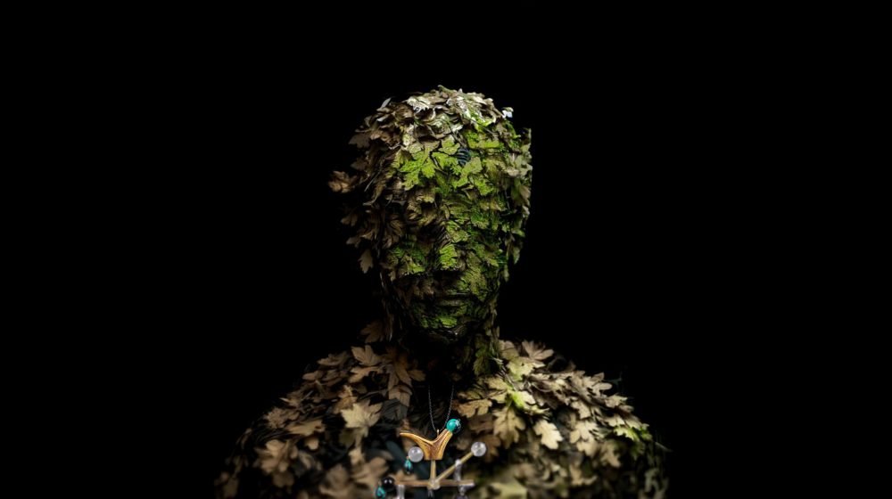 Applied anthropology jewelry from the Hunter Collection worn on a humanoid botanical figure, expressing dual orientation.