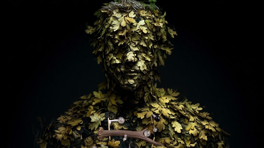 Wearable art jewelry from the Hunter Collection shown on a humanoid totem, expressing friction.