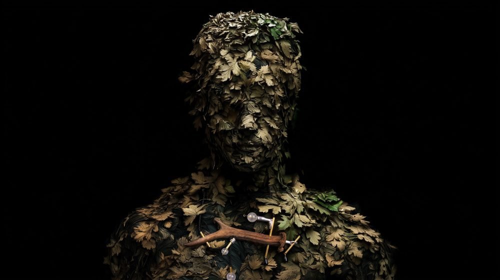 Wearable art jewelry from the Hunter Collection shown on a humanoid botanical totem, introducing orientation.