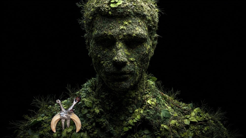 Wearable art jewelry from the Hunter Collection shown on a humanoid totem, exploring pre-linguistic identity.