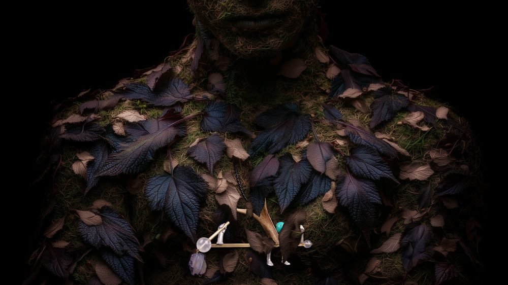 Applied anthropology jewelry from the Hunter Collection shown on a humanoid totem, suggesting symbolic environment.