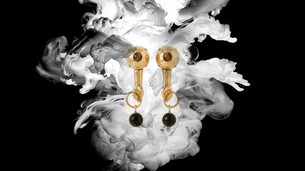 Secondary master image of the Milius piece “Pair,” created for the exclusive Luisa Via Roma Concentration chapter, presenting two suspended gold-toned elements aligned symmetrically within a dense, cloud-like field, emphasising duality, balance, and sustained relation.