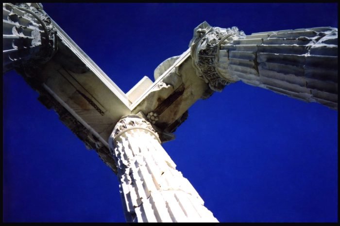 Ancient stone columns against deep blue sky photographed on analog film by Milan Stamenovic, exploring memory, sacred architecture, and humanity’s impermanence in The Ancient World Series.