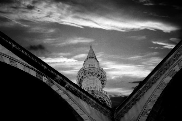 Ancient stone tower framed by sacred arches, photographed on analog film by Milan Stamenovic, exploring time, memory, and the endurance of sacred architecture in The Ancient World Series.